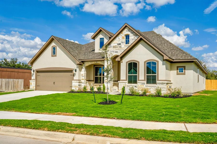 Front exterior of a new home in Buffalo Crossing, Schertz, TX, highlighting curb appeal (Image 2). Front exterior of a new home in Buffalo Crossing, Schertz, TX, highlighting curb appeal (Image 2).