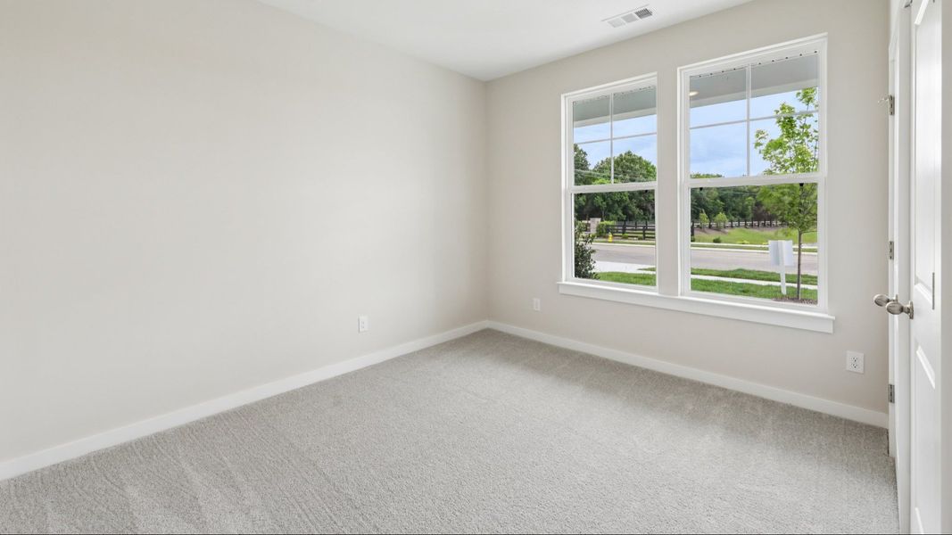 Bedroom with carpet and windows