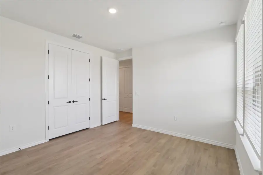 Unfurnished bedroom with light wood-style floors, a closet, and recessed lighting