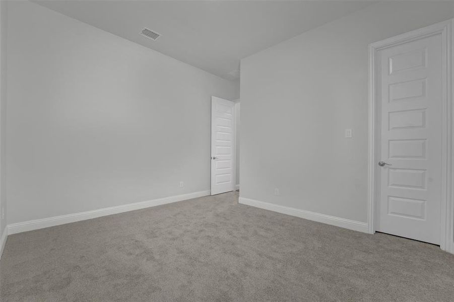 Unfurnished room featuring carpet and baseboards