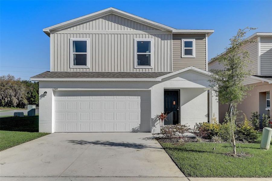 Front exterior of a new home in Bradbury Creek, Haines City, FL, highlighting curb appeal (Image 24). Front exterior of a new home in Bradbury Creek, Haines City, FL, highlighting curb appeal (Image 24).