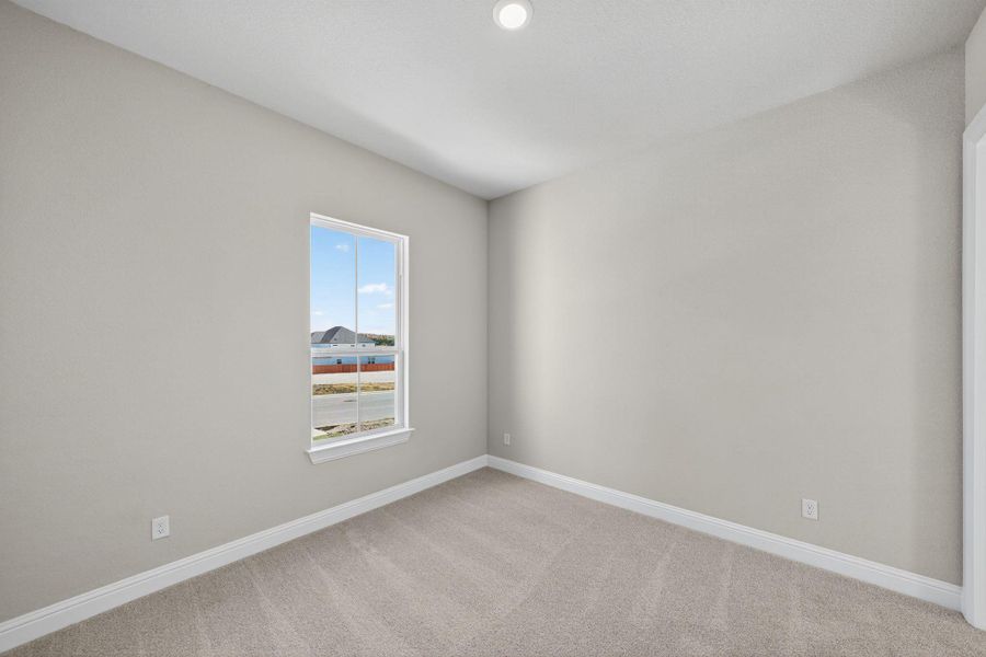 Unfurnished room with baseboards and carpet floors Unfurnished room with baseboards and carpet floors