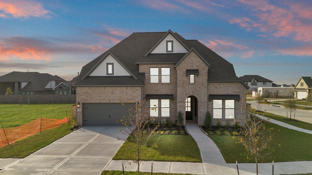 Front exterior of a new home in Valencia 60', Manvel, TX, highlighting curb appeal (Image 23).