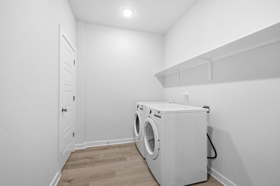 A well-lit laundry room offers convenient appliances and ample storage space.