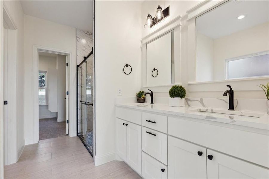 Bathroom with vanity and a shower with shower door