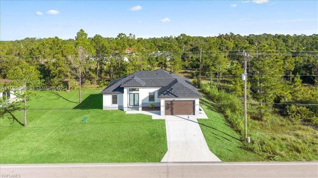 Front exterior of a new home in , Lehigh Acres, FL, highlighting curb appeal (Image 24).