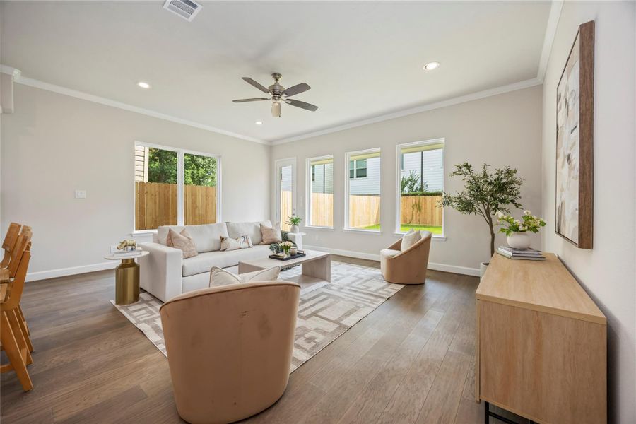 Bask in the warmth of the living room, where neutral light walls and exquisite light wood floors craft an ambiance of understated elegance.