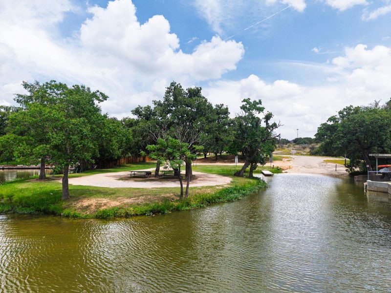 Discover a tranquil lakeside retreat with a private boat launch and lush greenery.