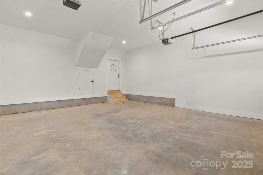 Fully finished over sized two car garage. There is also a storage area behing the small door that uses the space under the stairs