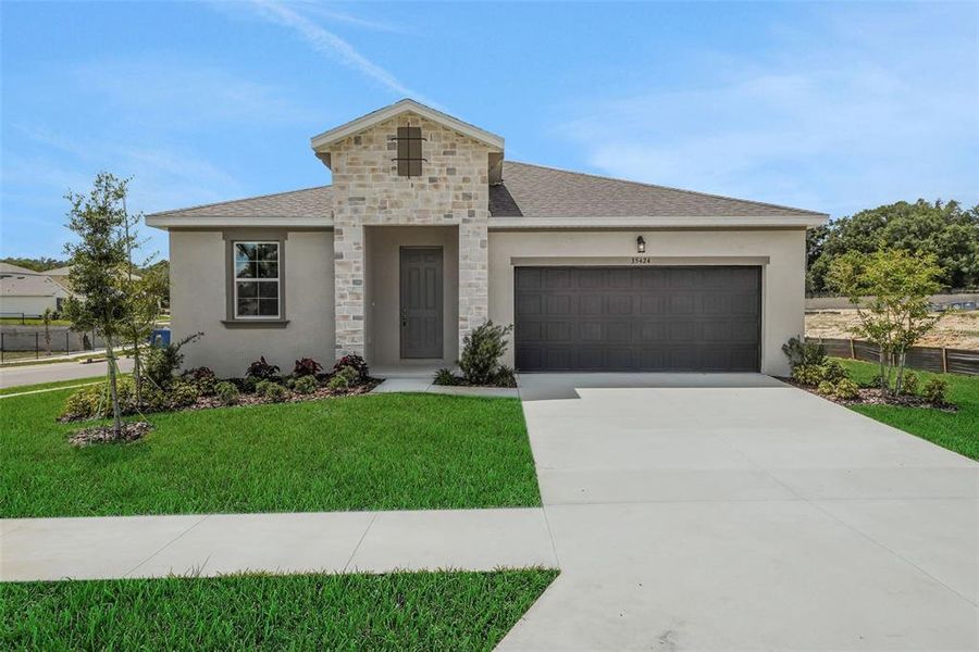 Front exterior of a new home in Tuscan Hills, Dade City, FL, highlighting curb appeal (Image 22).