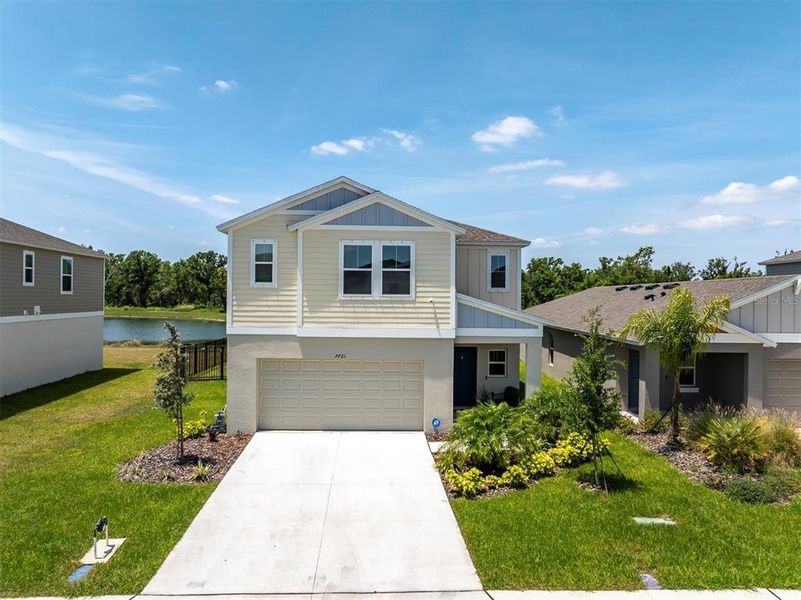 Front exterior of a new home in Crosswind Point, Parrish, FL, highlighting curb appeal (Image 20).