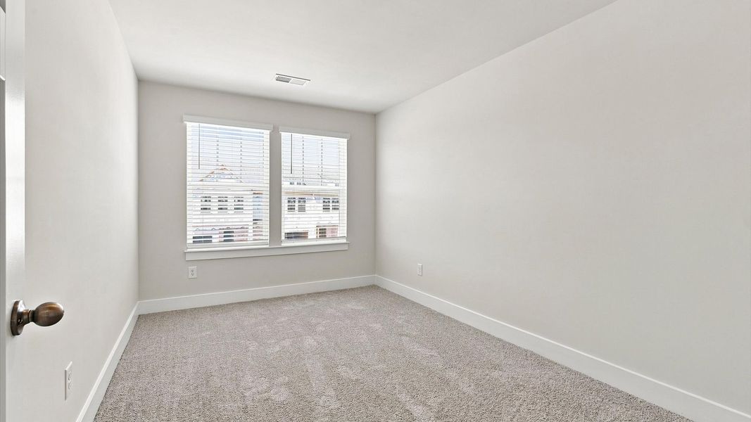 Memorable space with walk-in closet, soft carpeting, and striking natural light from large windows at Saluda Crossing Memorable space with walk-in closet, soft carpeting, and striking natural light from large windows at Saluda Crossing