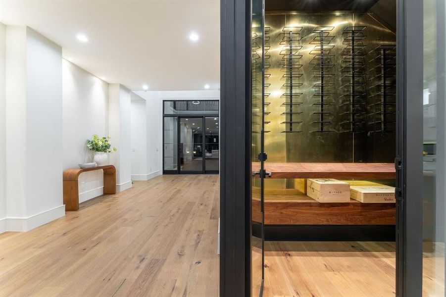 Wine room with light wood-type flooring