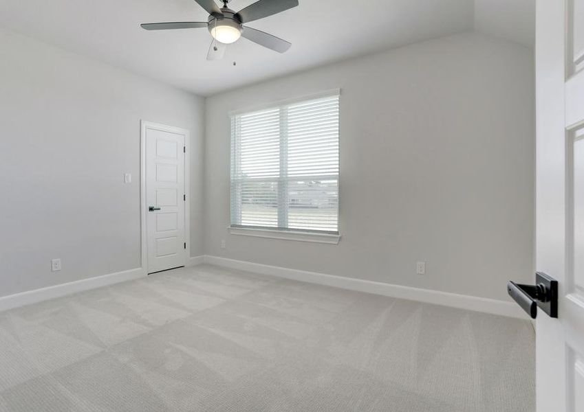 Secondary bedroom with a window and ceiling fan.