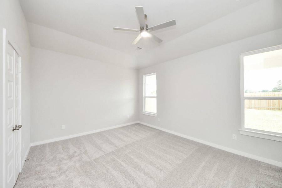 Retreat to the luxurious primary suite, your perfect escape for unwinding after a long day. Located on the first floor, this spacious room features plush carpeting, calming paint tones, high ceilings, and large windows with privacy blinds. Retreat to the luxurious primary suite, your perfect escape for unwinding after a long day. Located on the first floor, this spacious room features plush carpeting, calming paint tones, high ceilings, and large windows with privacy blinds.