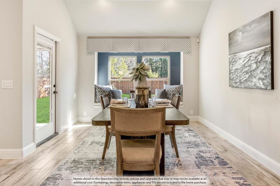 Dining room with wood table, built-in bench seating, large window, and light hardwood floors Dining room with wood table, built-in bench seating, large window, and light hardwood floors