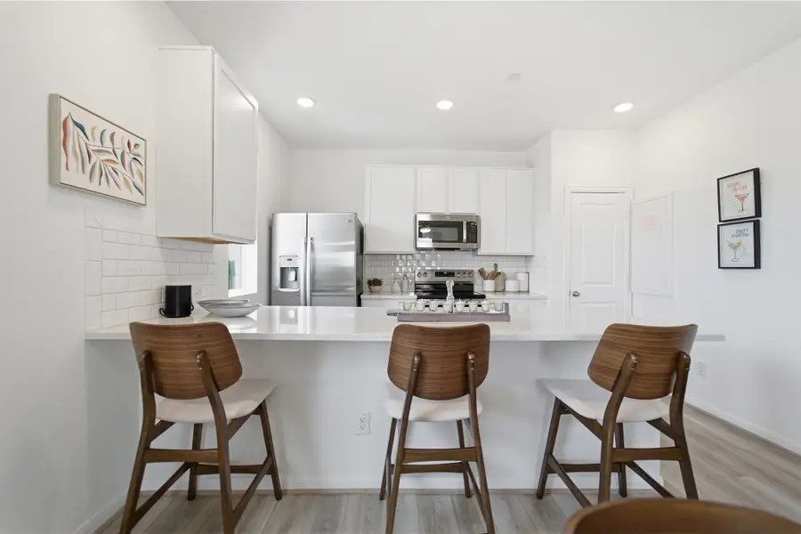 Representative furnished interior of a home built from the Kahn by CastleRock Communities in Municipal Drive Townhomes, Leander (Image 10).