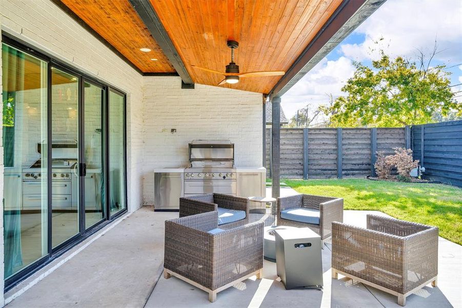 View of patio featuring ceiling fan, an outdoor living space, area for grilling, and grilling area