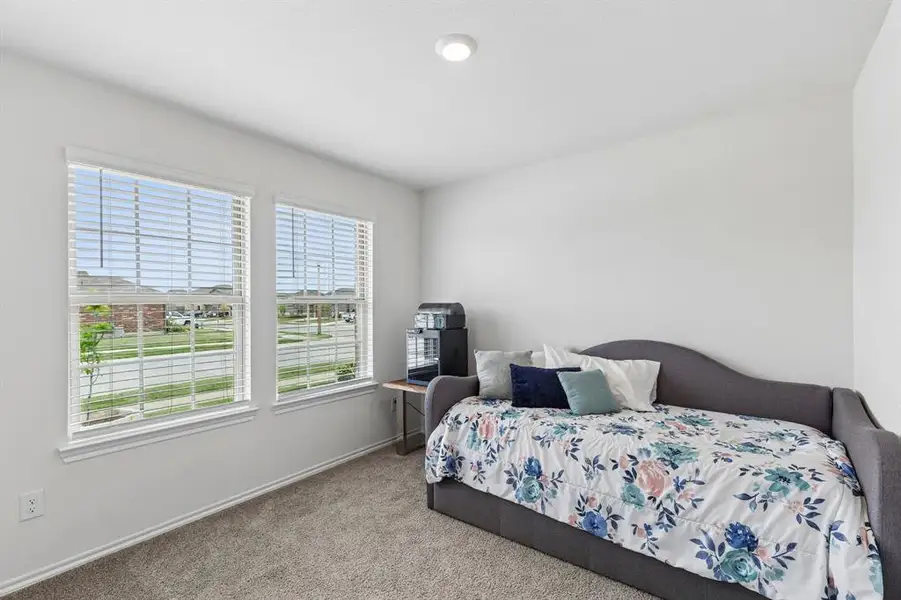 Bedroom with carpet floors and baseboards Bedroom with carpet floors and baseboards