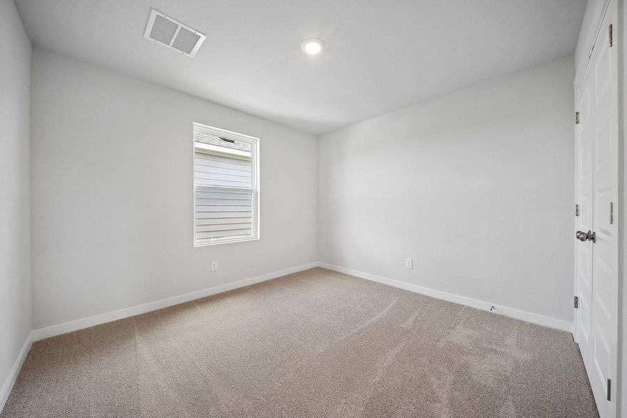 A well-lit bedroom offering a neutral palette, ready for personalization. A well-lit bedroom offering a neutral palette, ready for personalization.