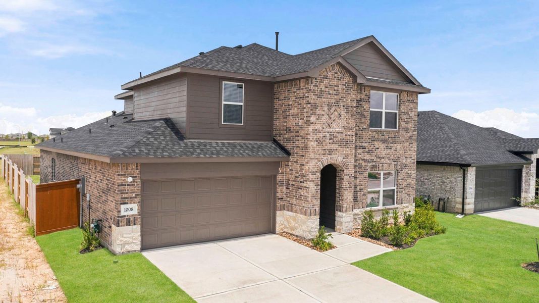 Front exterior of a new home in Sunterra Lakes, Brookshire, TX, highlighting curb appeal (Image 22).