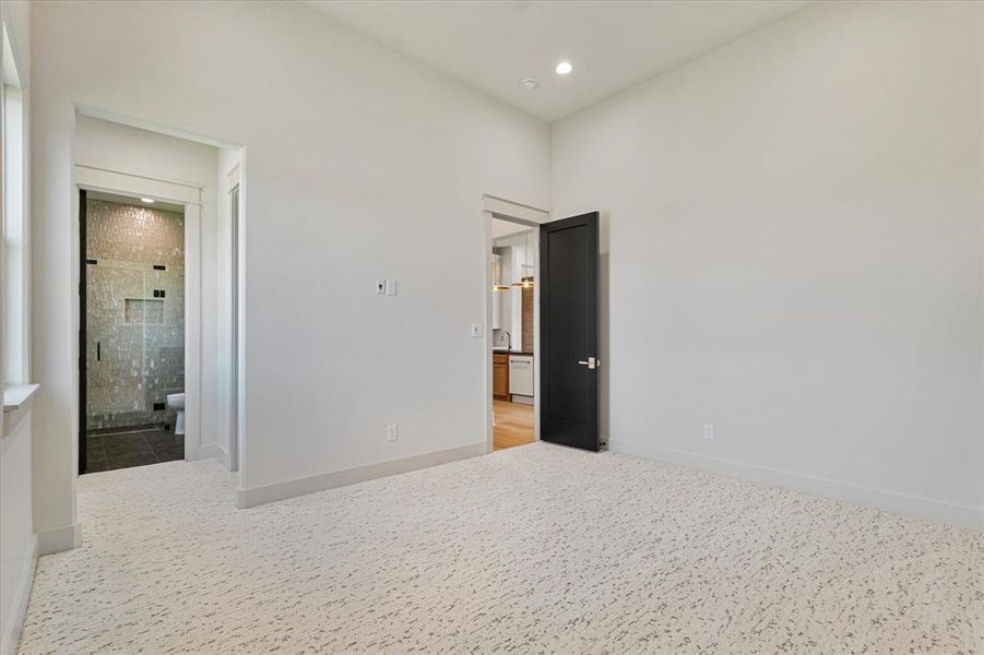 Unfurnished bedroom with recessed lighting and ensuite bath