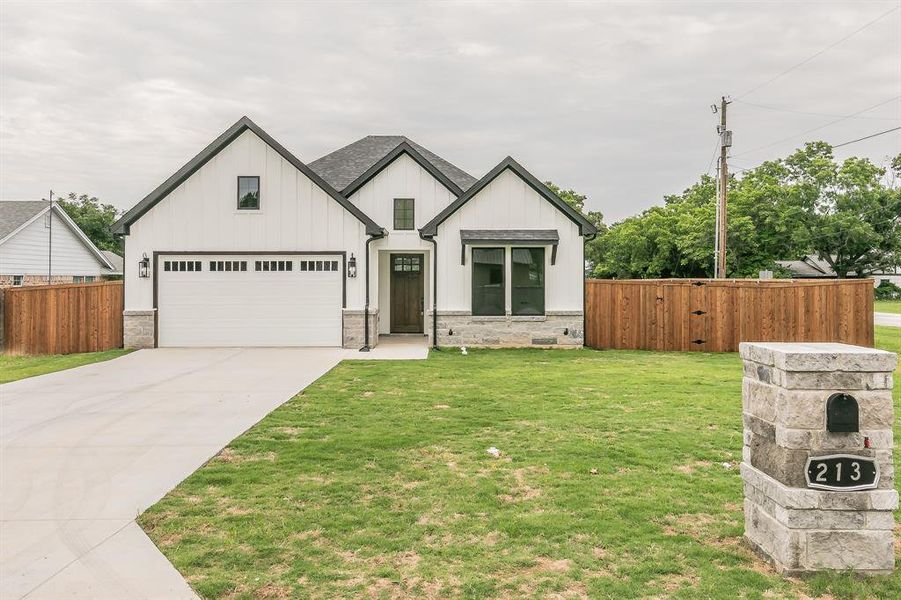 View of front of house featuring board and batten siding, concrete driveway, and a garage View of front of house featuring board and batten siding, concrete driveway, and a garage