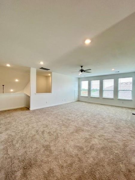 Spacious carpeted game room featuring recessed lighting and a ceiling fan