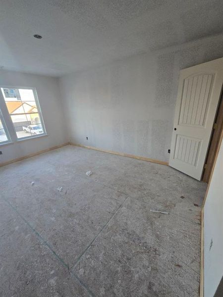 Empty room featuring baseboards and a textured ceiling