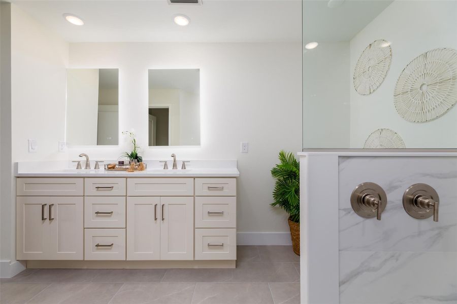 Luxury dual temperature controls with both rainforest and standard shower head for a spa-like experience