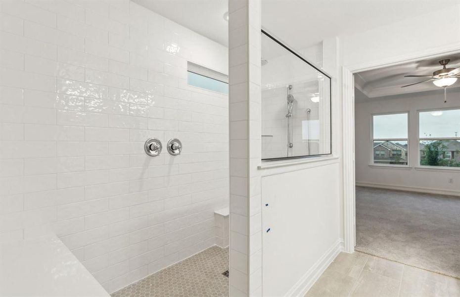 Owner's suite bath with a luxurious deep walk-in shower *Real home pictured