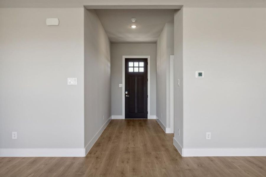 Entryway with light hardwood / wood-style floors