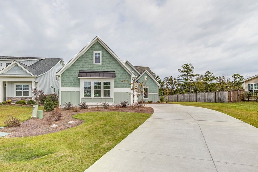 Representative exterior photo of a completed home built from the The Amherst by RobuckHomes in Windwater, Hampstead, NC (Image 24).