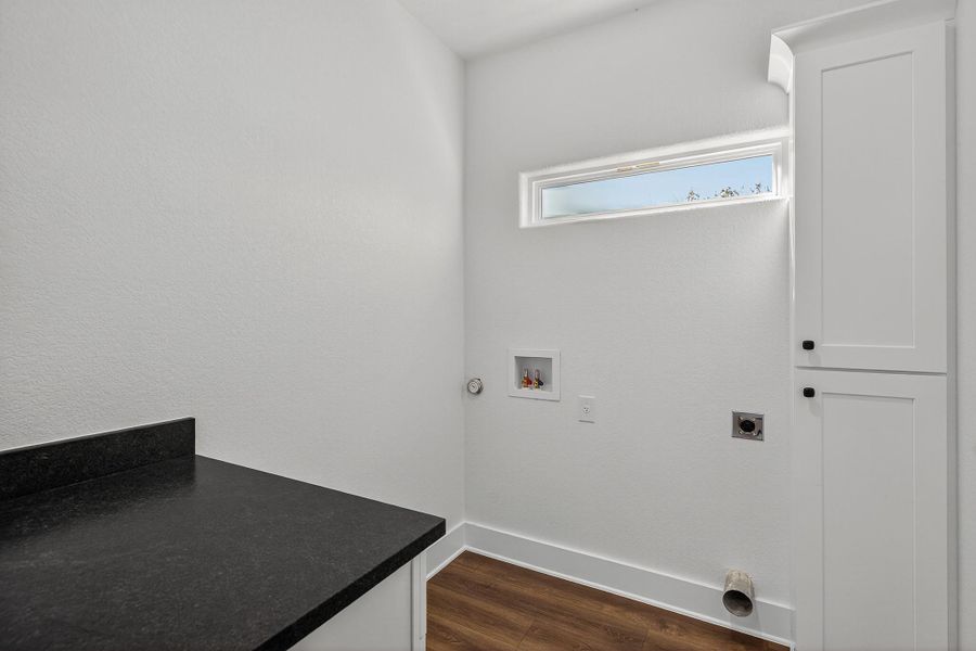 Laundry room with dark wood-style flooring, cabinet space, washer hookup, and electric dryer hookup Laundry room with dark wood-style flooring, cabinet space, washer hookup, and electric dryer hookup