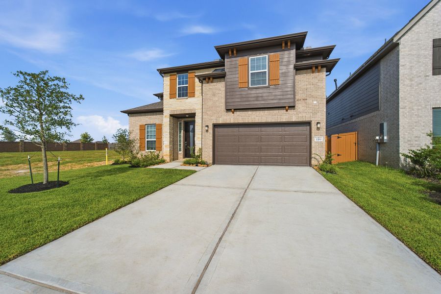 Front exterior of a new home in Lago Mar, Texas City, TX, highlighting curb appeal (Image 2). Front exterior of a new home in Lago Mar, Texas City, TX, highlighting curb appeal (Image 2).