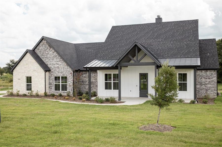 Modern farmhouse with covered porch, a standing seam roof, board and batten siding, and roof with shingles Modern farmhouse with covered porch, a standing seam roof, board and batten siding, and roof with shingles