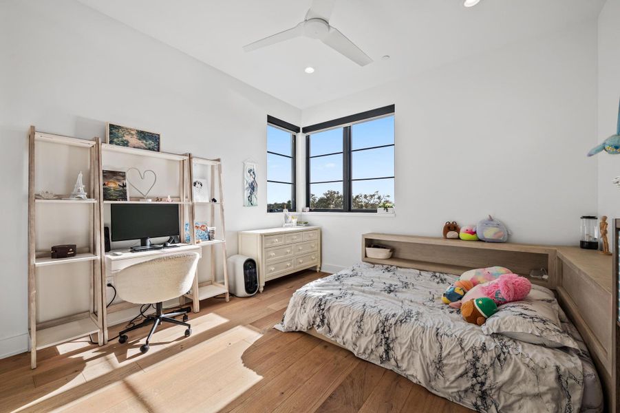 Bedroom with wood finished floors, recessed lighting, and a ceiling fan Bedroom with wood finished floors, recessed lighting, and a ceiling fan