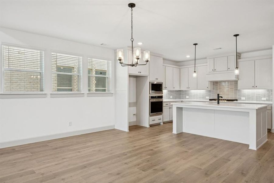 The kitchen-dining area create the perfect space for grand dinner parties or cozy family meals.
