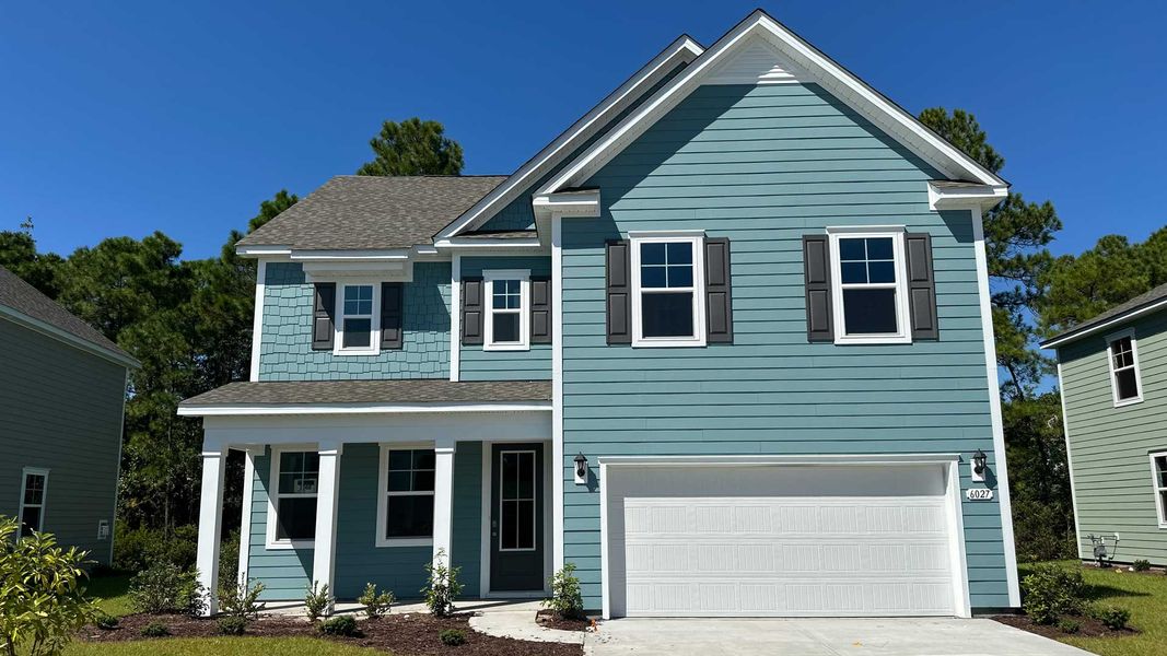 Front exterior of a new home in Waterbridge, Myrtle Beach, SC, highlighting curb appeal (Image 1).