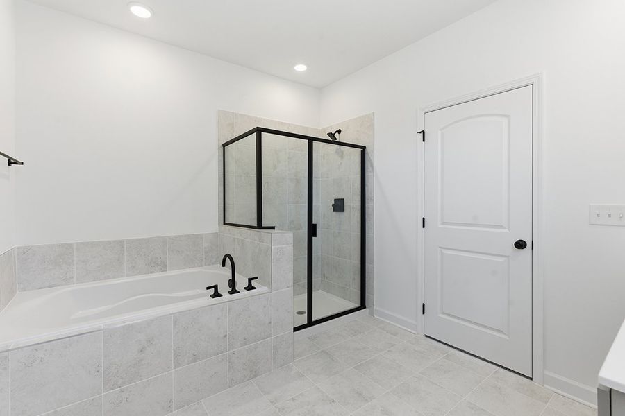 A bathroom with a bathtub and shower.