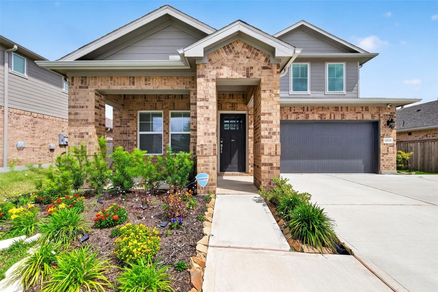 Front exterior of a new home in Heights of Barbers Hill, Baytown, TX, highlighting curb appeal (Image 24).