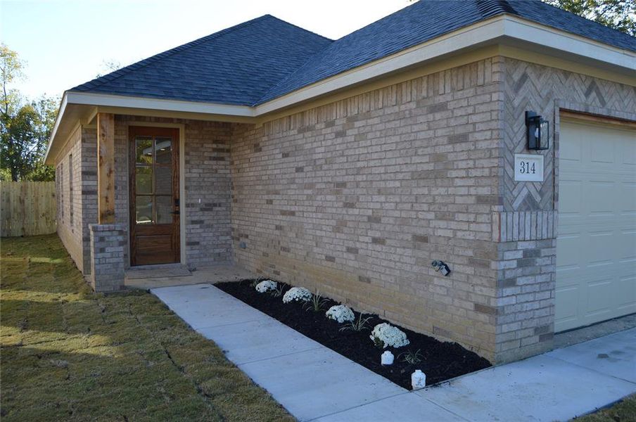 Property entrance featuring a garage