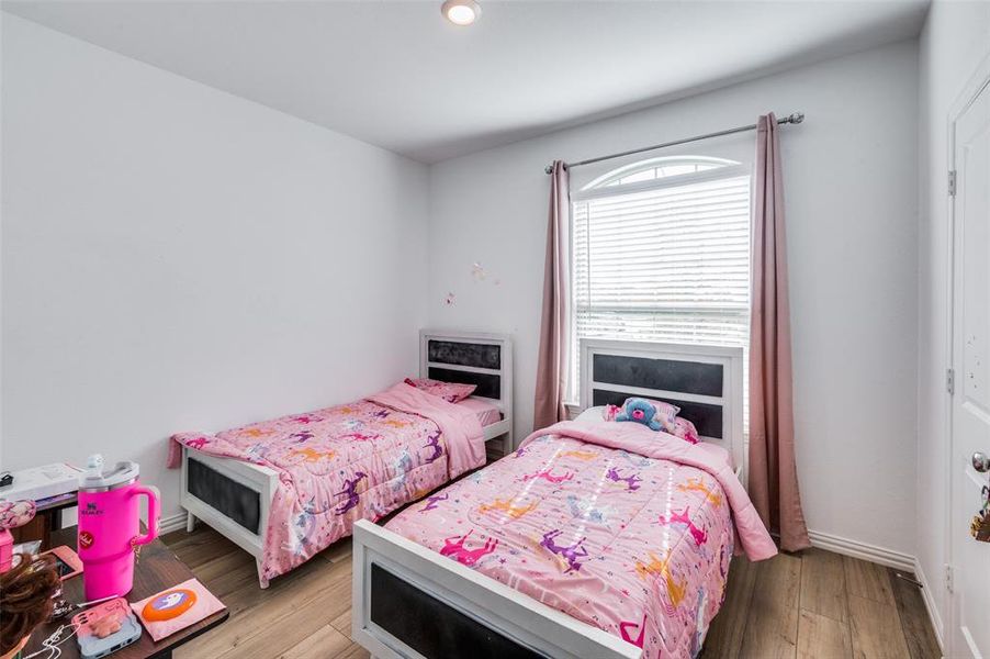 Bedroom with light hardwood / wood-style floors