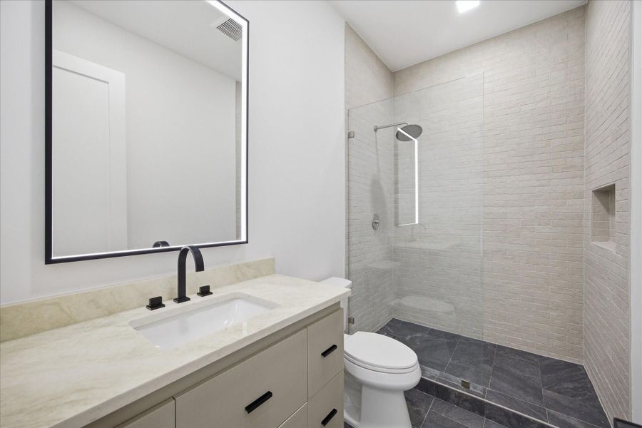 Thoughtfully selected tilework and glass-enclosed showers bring a refined, spa-inspired feel.