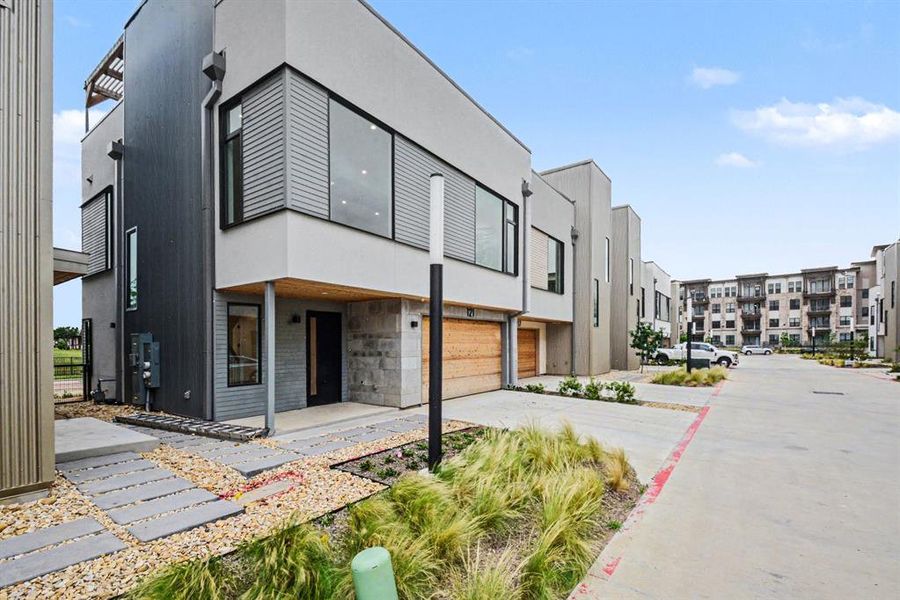 Modern luxury with sweeping windows, 2-car garage, and roof-top pergola.