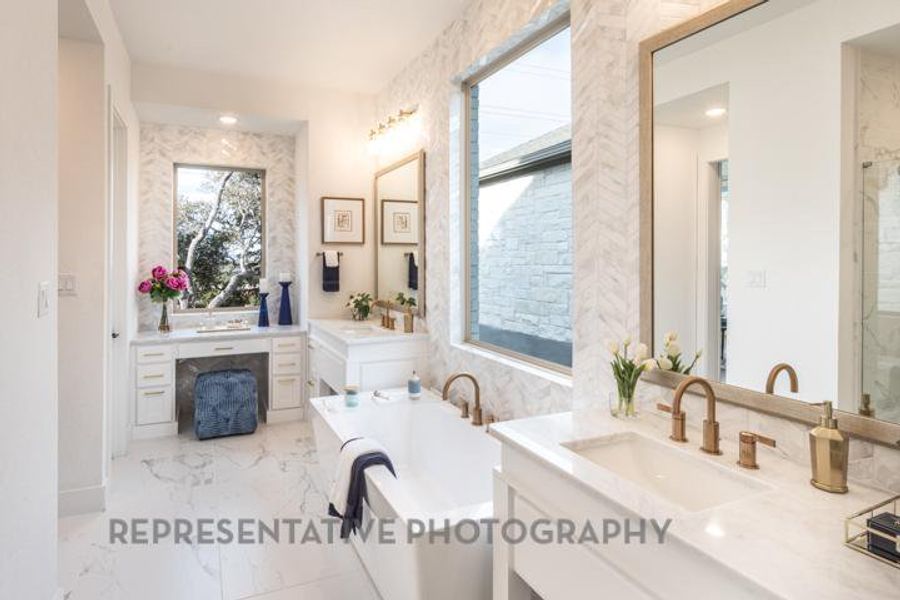 Full bathroom featuring a sink, two vanities, a bath, and marble finish floor Full bathroom featuring a sink, two vanities, a bath, and marble finish floor