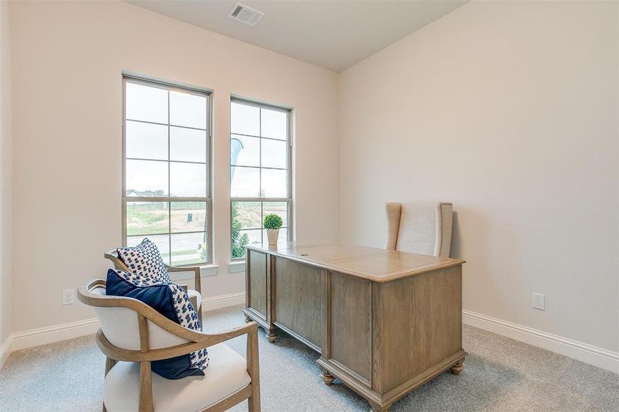 Office area featuring light colored carpet and a wealth of natural light