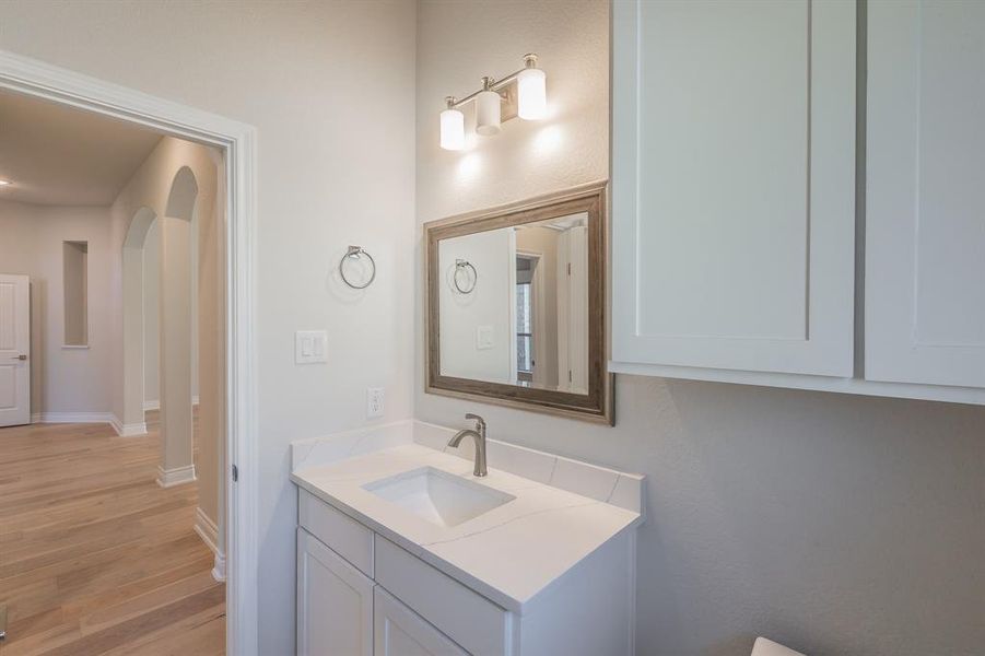 Bathroom featuring hardwood / wood-style floors and vanity