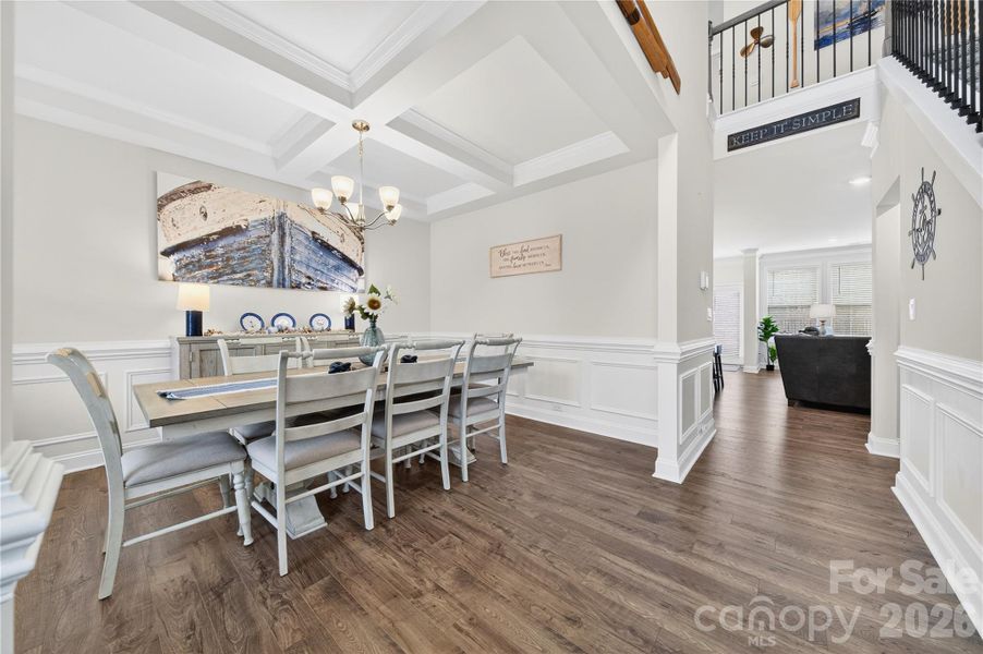 Dining room boasts coffered ceilings and decorative trim.