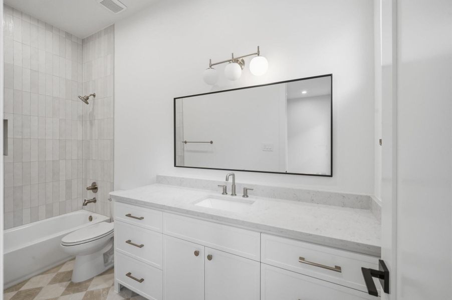 Bath 2 offers mosaic tile floor, quartz countertops and tub/shower combo.